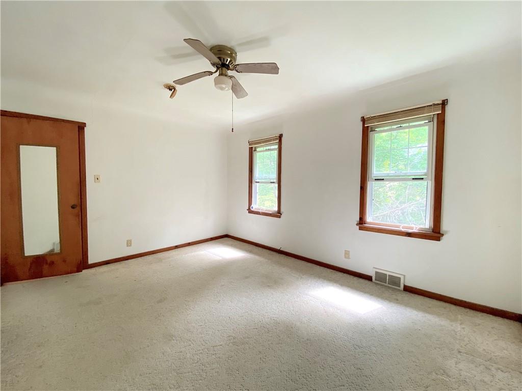 250 Spring Valley Road Jeannette, PA 15644 - Photo 16 of 16 an empty room with windows and fan