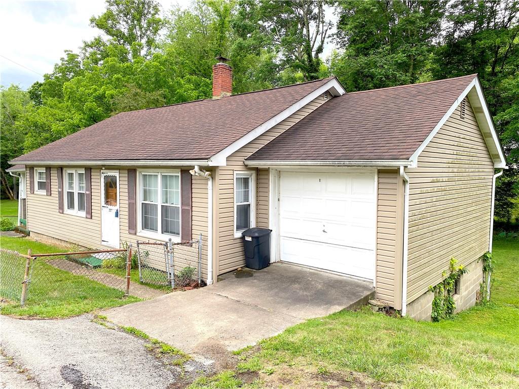 250 Spring Valley Road Jeannette, PA 15644 - Photo 2 of 16 a view of a house with a yard and plants