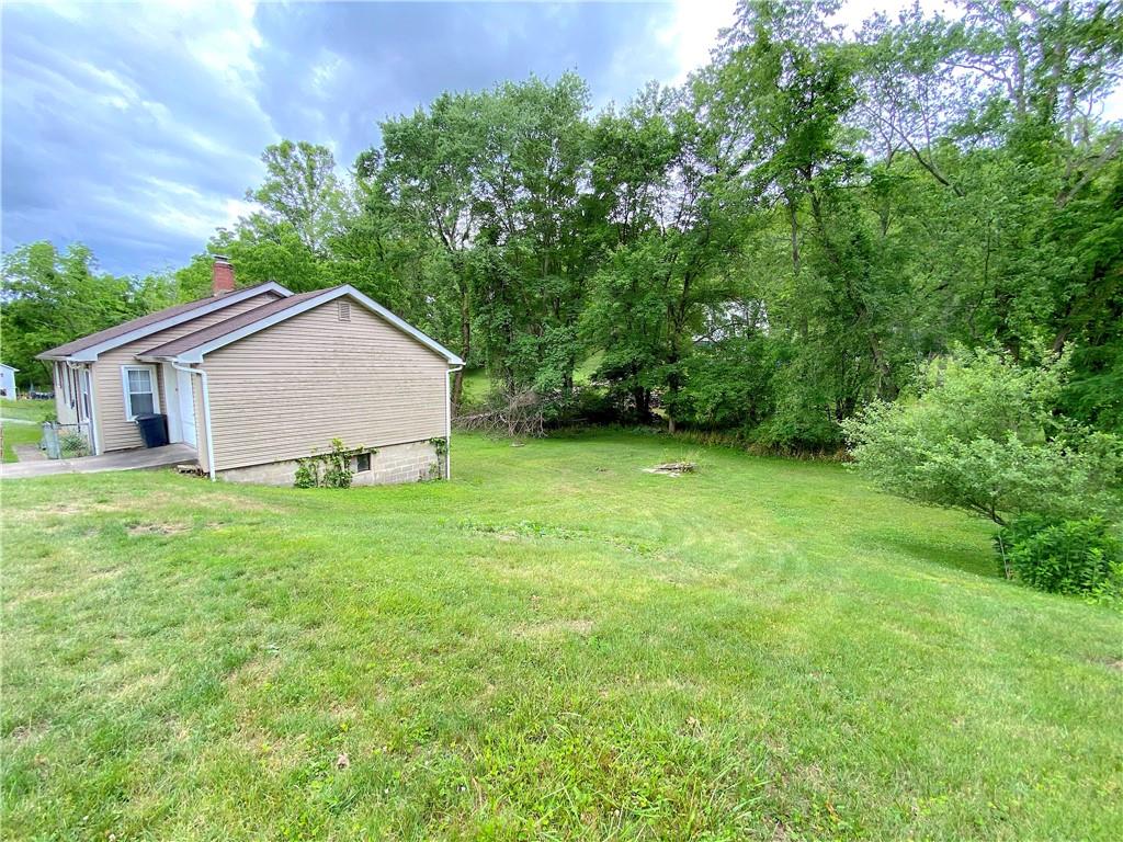 250 Spring Valley Road Jeannette, PA 15644 - Photo 4 of 16 a view of an house with backyard space and garden