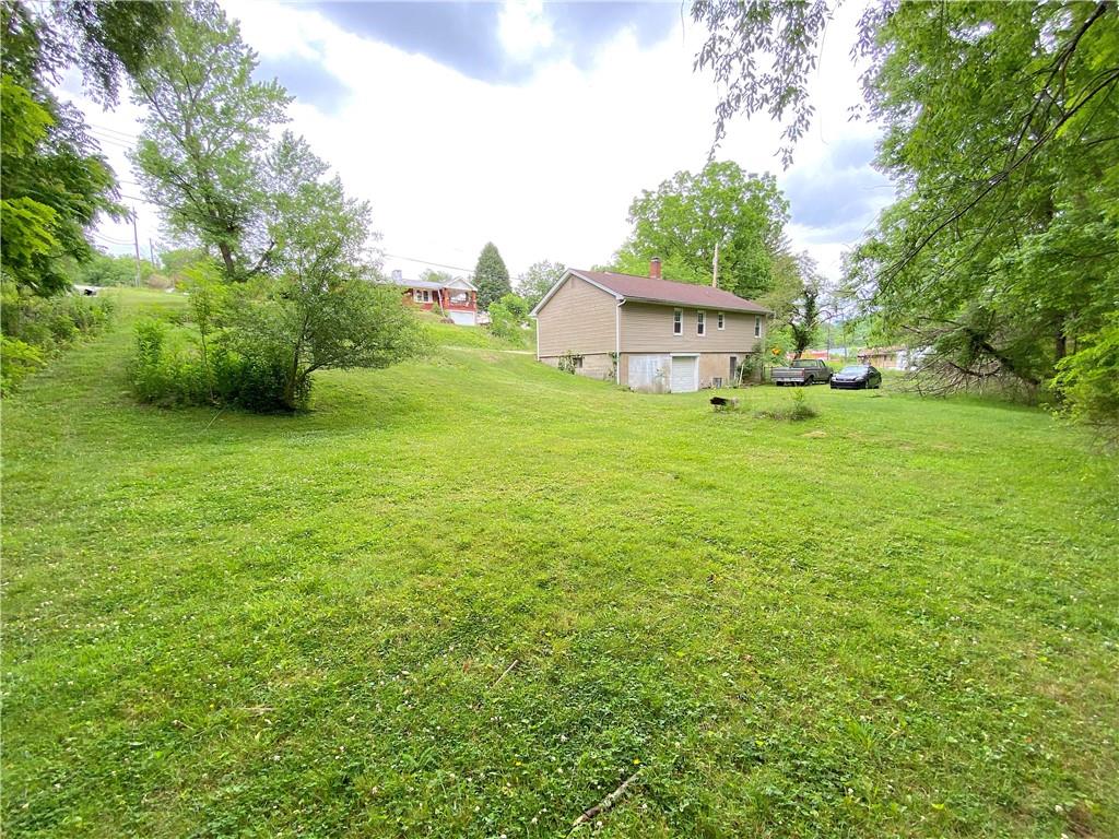 250 Spring Valley Road Jeannette, PA 15644 - Photo 5 of 16 a view of a house with a backyard