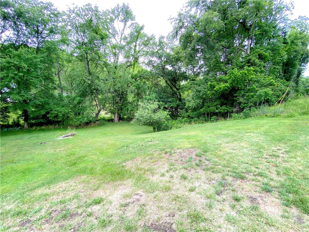 250 Spring Valley Road Jeannette, PA 15644 - Photo 6 of 16 a view of a grassy field with trees in the background