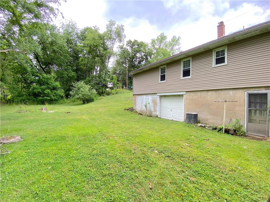 250 Spring Valley Road Jeannette, PA 15644 - Photo 7 of 16 a view of a backyard with plants and large tree