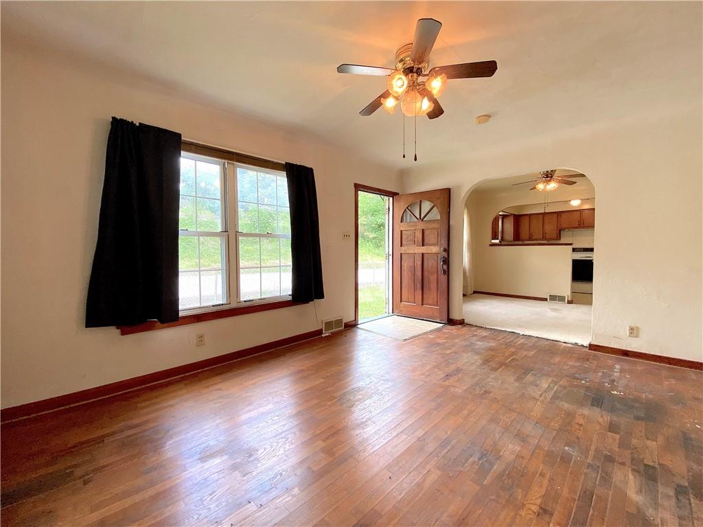 250 Spring Valley Road Jeannette, PA 15644 - Photo 9 of 16 a view of an empty room with a window and wooden floor