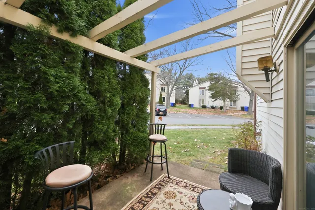 a view of a porch with furniture and a yard