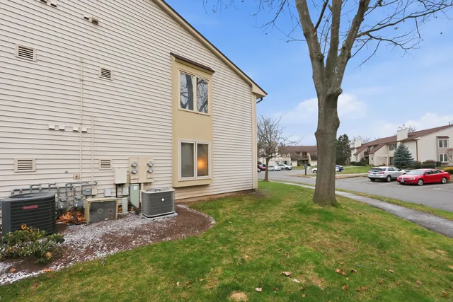 a backyard of a house with table and chairs