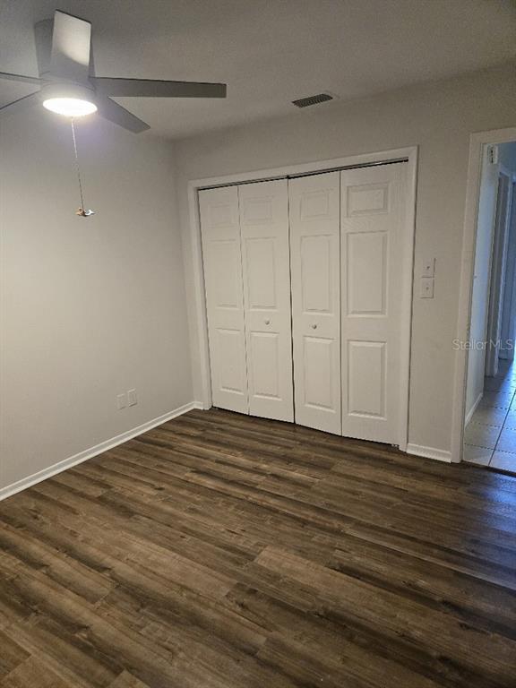 156 Devon Court Dunedin, FL 34698 - Photo 11 of 21 a view of an empty room with wooden floor