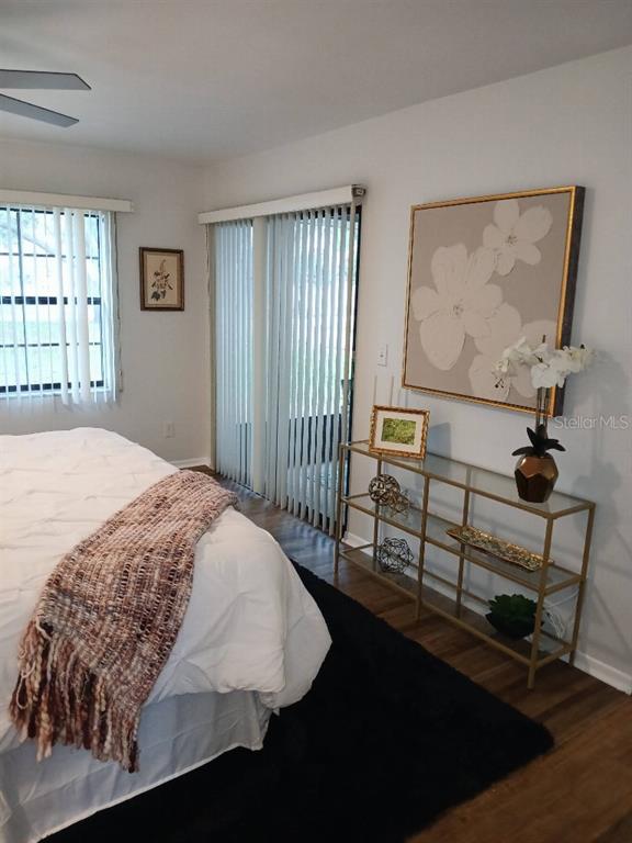 156 Devon Court Dunedin, FL 34698 - Photo 18 of 21 a bedroom with a bed painting on wall and a window