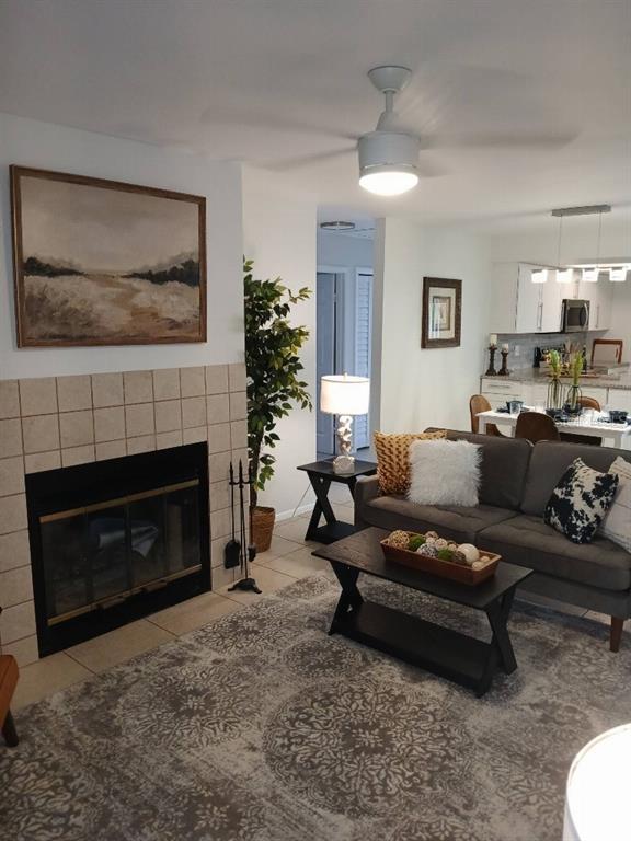 156 Devon Court Dunedin, FL 34698 - Photo 4 of 21 a living room with furniture a fireplace and a flat screen tv