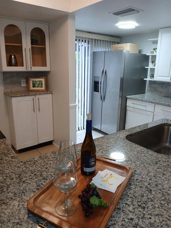 156 Devon Court Dunedin, FL 34698 - Photo 8 of 21 a view of a refrigerator in kitchen