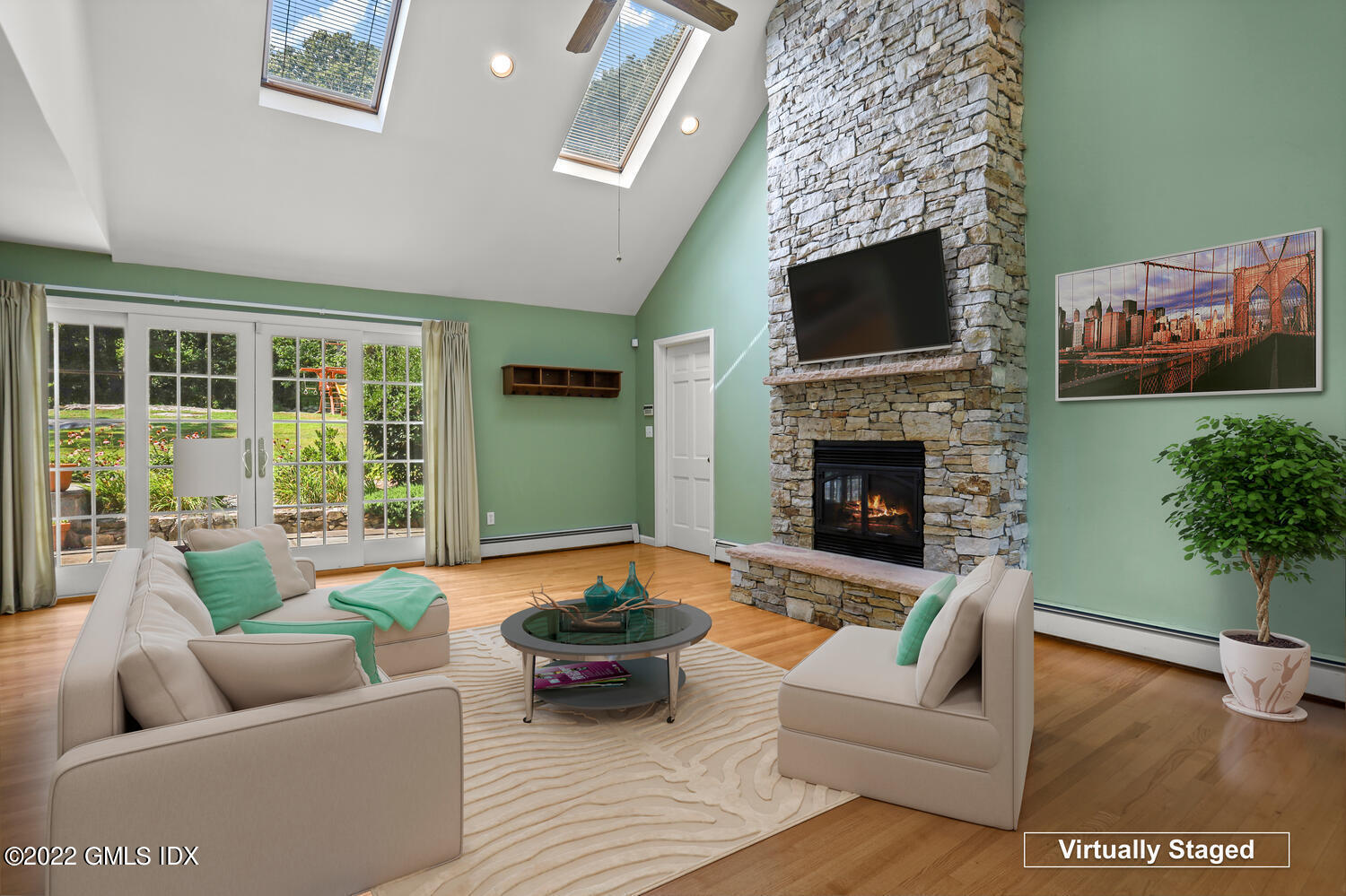 1 Sundance Drive Cos Cob, CT 06807 - Photo 14 of 50 a living room with furniture a flat screen tv and a fireplace