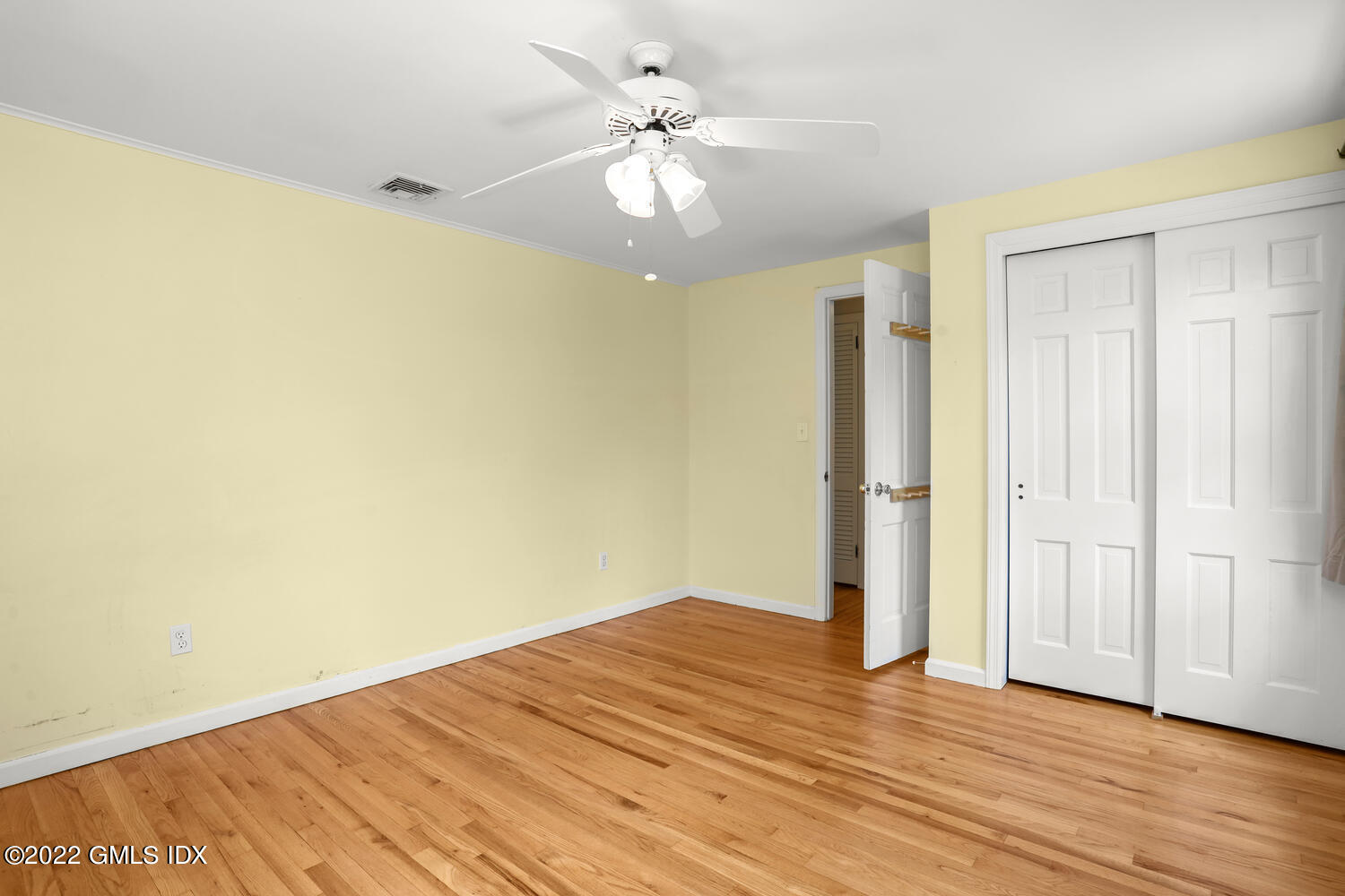 1 Sundance Drive Cos Cob, CT 06807 - Photo 32 of 50 an empty room with wooden floor and ceiling fan