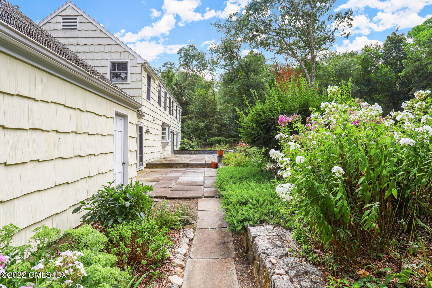1 Sundance Drive Cos Cob, CT 06807 - Photo 39 of 50 a view of a pathway of a house with flower garden