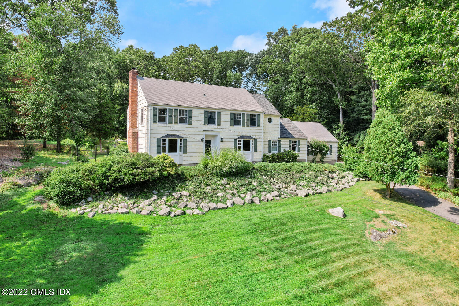 1 Sundance Drive Cos Cob, CT 06807 - Photo 47 of 50 a front view of a house with garden and porch