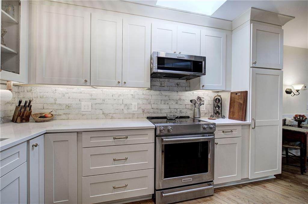 213 South View Trail Jasper, GA 30143 - Photo 19 of 79 a kitchen with granite countertop white cabinets and stainless steel appliances