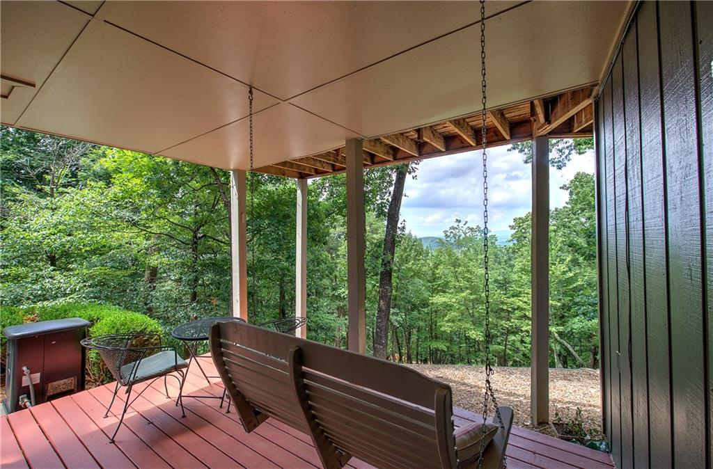 213 South View Trail Jasper, GA 30143 - Photo 51 of 79 a view of a chair and table in the deck under an umbrella