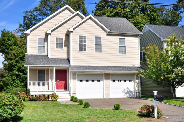 a view of house with yard and front view of a house