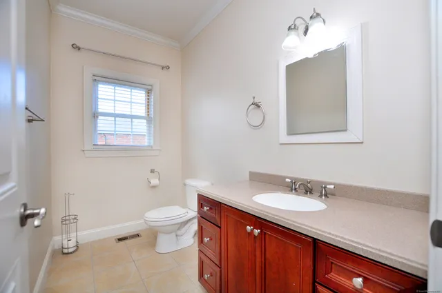a bathroom with a sink a toilet and a mirror