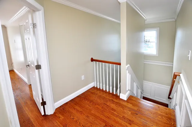 a view of a room with wooden floor and stairs