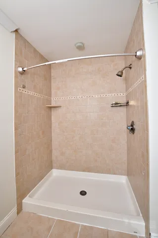 a bathroom with a shower and a bath tub