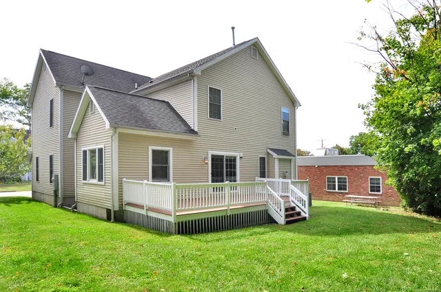 a view of a house with a backyard