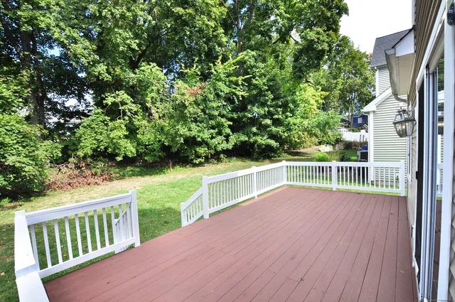 a view of balcony with deck and yard