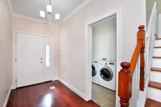 a view of a storage and utility room with wooden floor