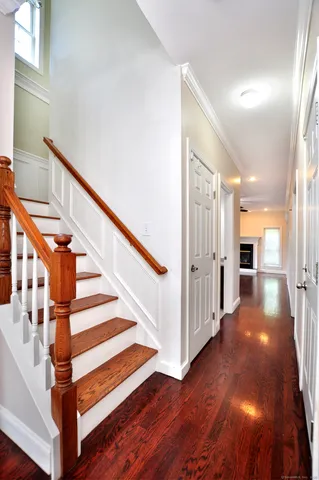 a view of entryway with wooden floor and stairs