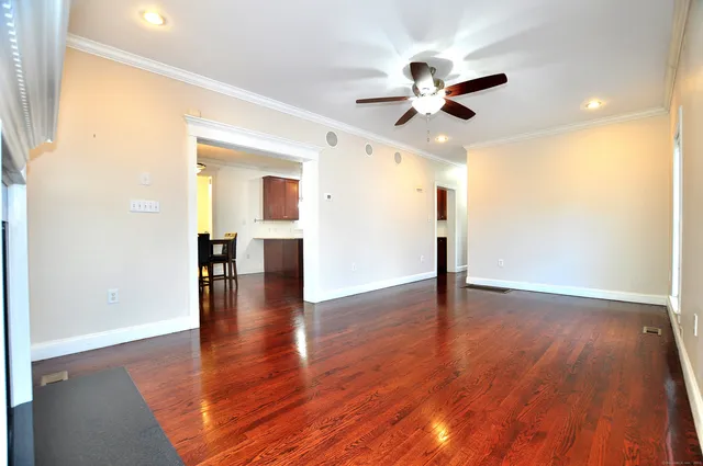 a view of empty room with wooden floor