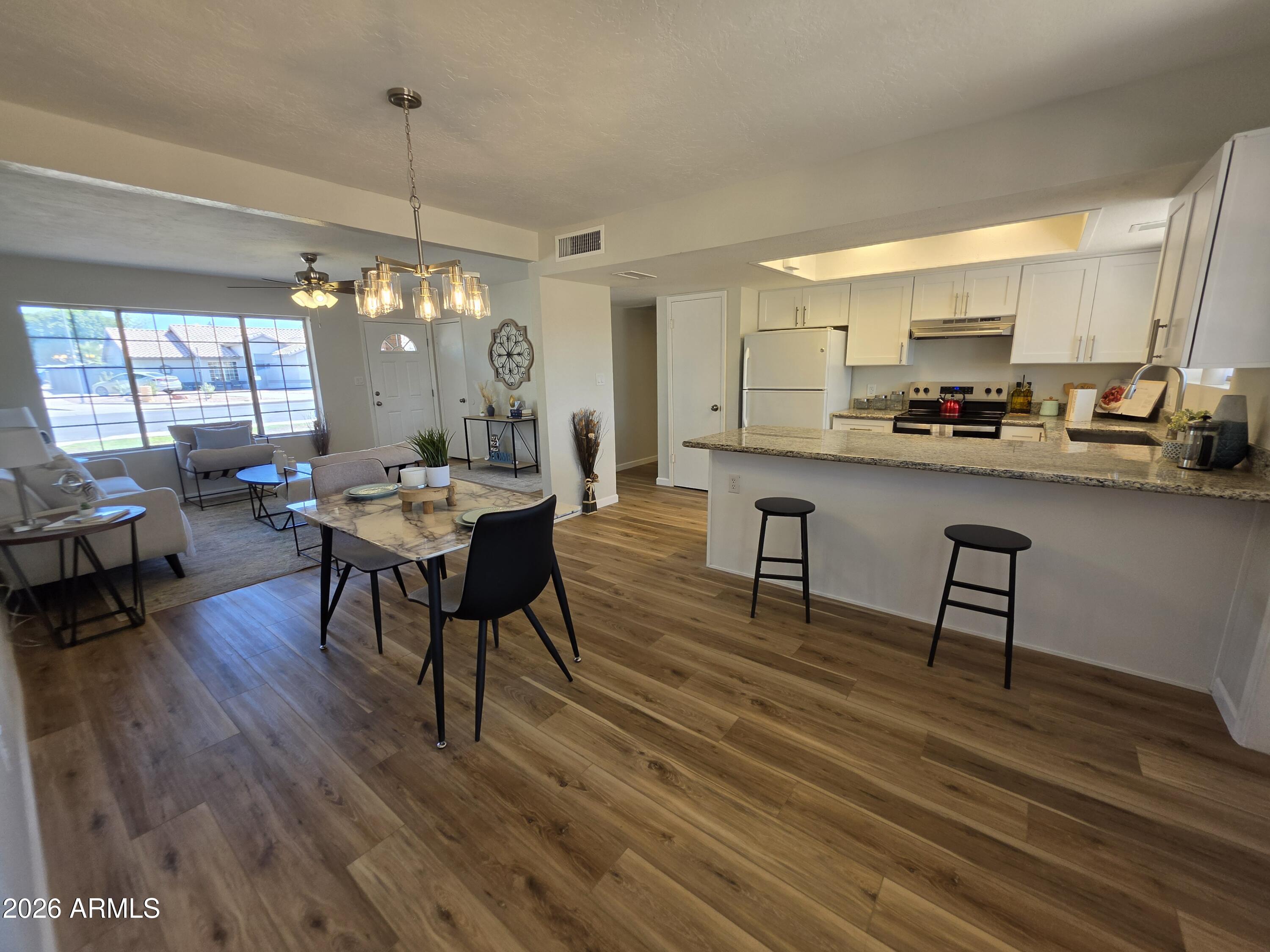 46 East McLellan Road Mesa, AZ 85201 - Photo 1 of 18 a living room with furniture and a chandelier
