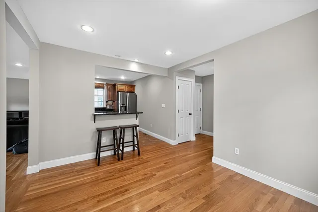 a view of a room with wooden floor and furniture