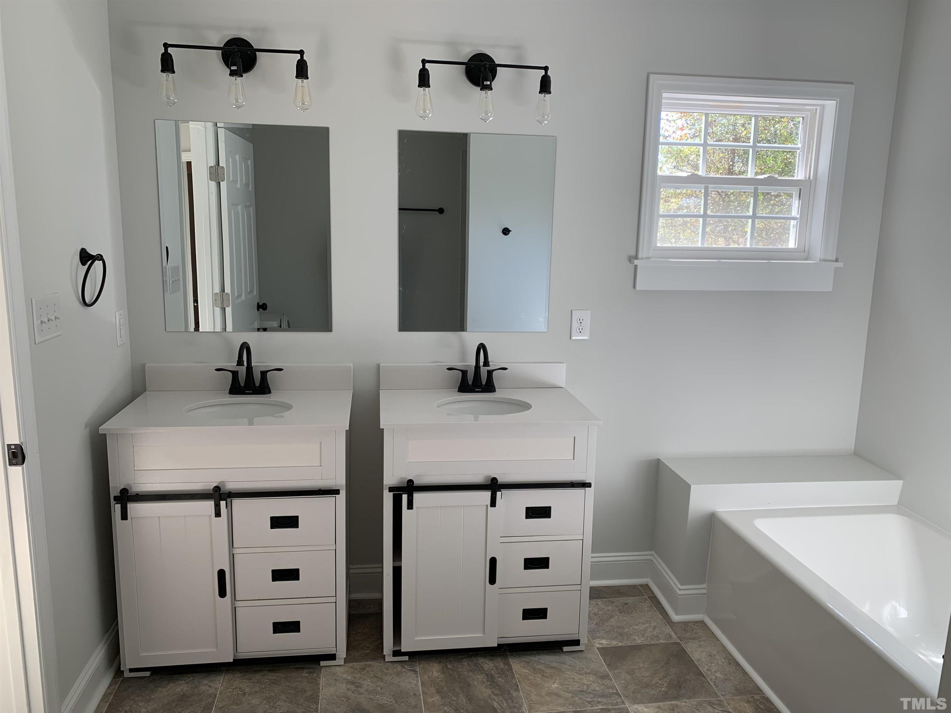 337 Chisenhall Road Angier, NC 27501 - Photo 4 of 7 a bathroom with a double vanity sink and mirror
