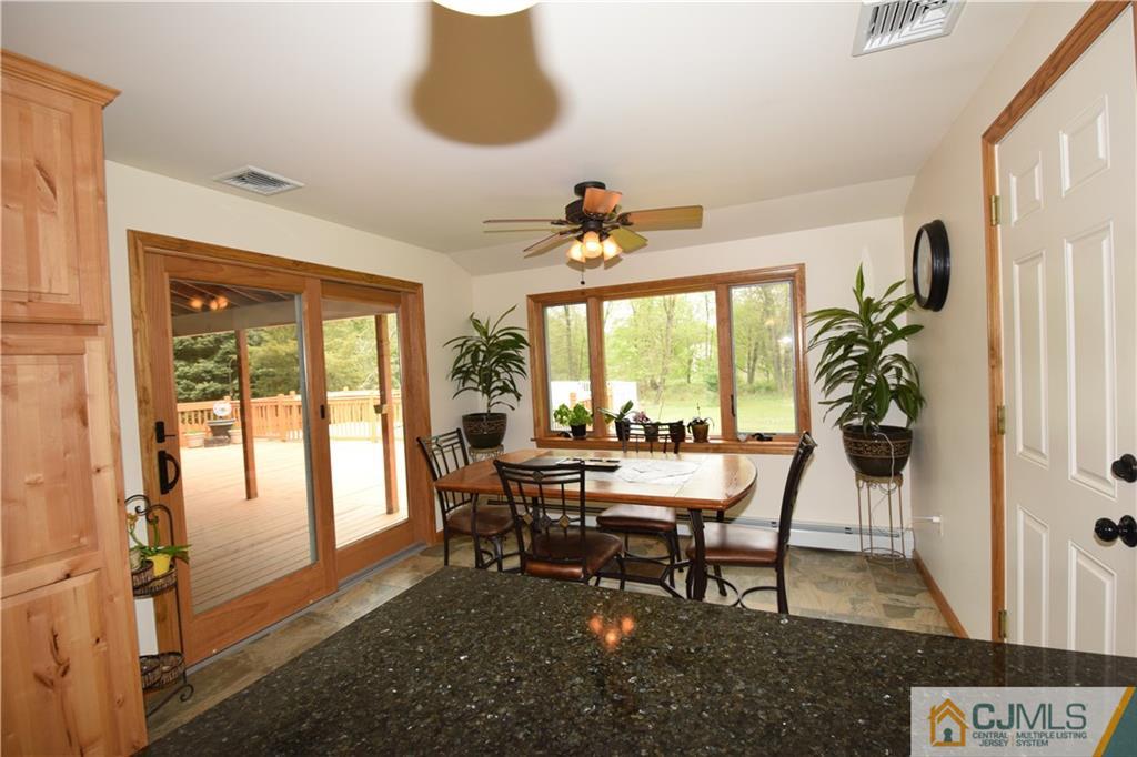 65 Warrenville Road Middlesex, NJ 08846 - Photo 11 of 22 a dining room with furniture and a floor to ceiling window