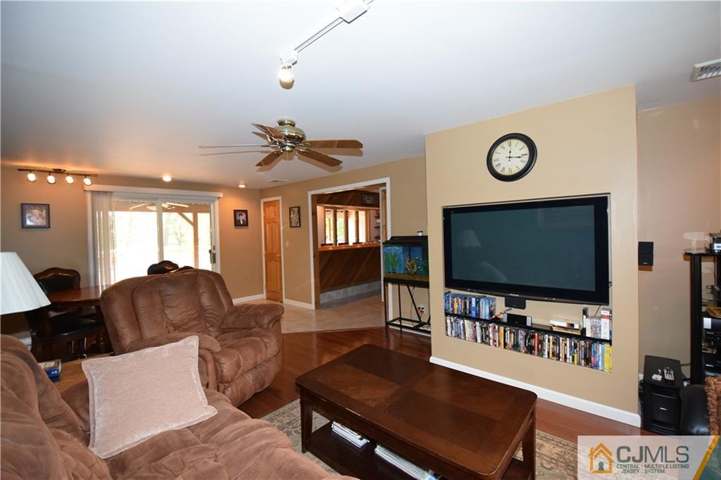 65 Warrenville Road Middlesex, NJ 08846 - Photo 12 of 22 a living room with furniture and a flat screen tv