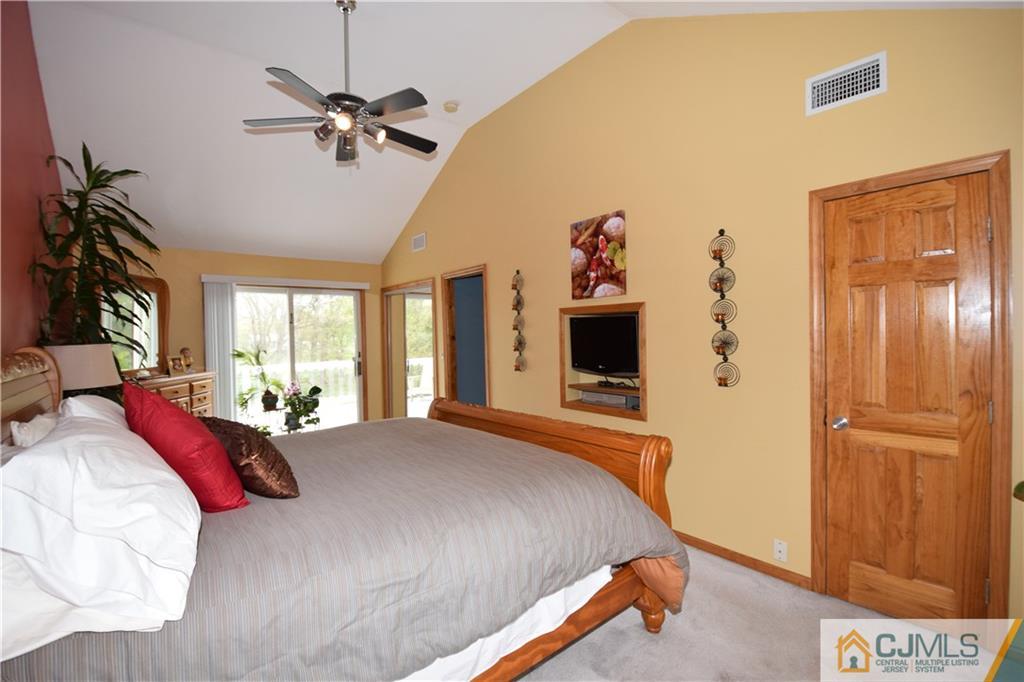 65 Warrenville Road Middlesex, NJ 08846 - Photo 19 of 22 a bedroom with a bed and a flat tv screen