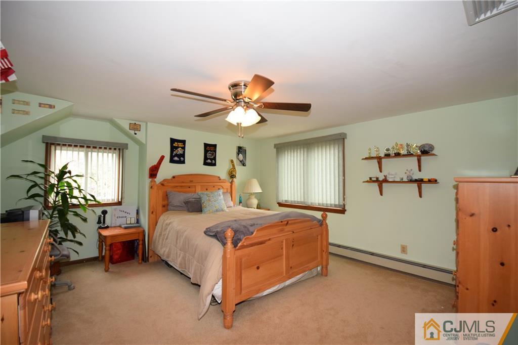65 Warrenville Road Middlesex, NJ 08846 - Photo 20 of 22 a bedroom with a bed and a chandelier