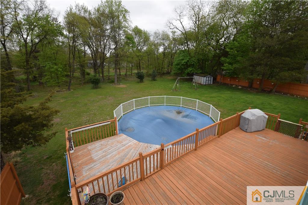 65 Warrenville Road Middlesex, NJ 08846 - Photo 3 of 22 a view of a wooden deck with garden