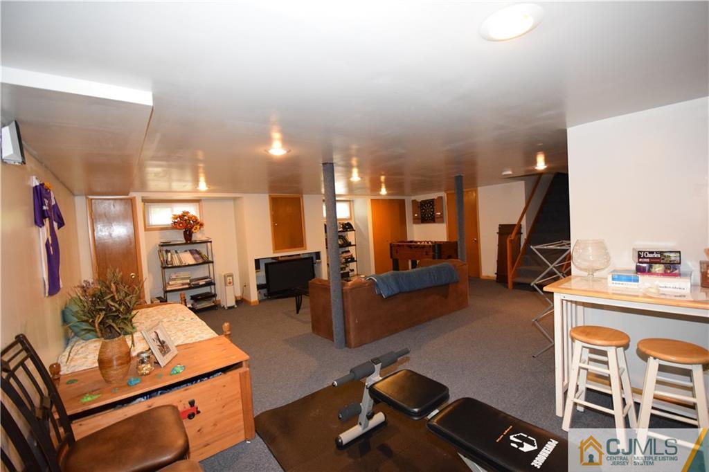 65 Warrenville Road Middlesex, NJ 08846 - Photo 22 of 22 a living room with furniture and a flat screen tv
