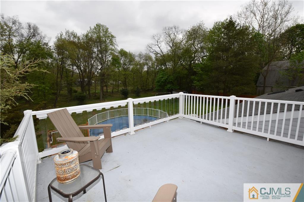 65 Warrenville Road Middlesex, NJ 08846 - Photo 5 of 22 a view of a chairs and table in the roof deck