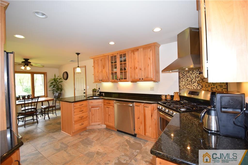 65 Warrenville Road Middlesex, NJ 08846 - Photo 8 of 22 a kitchen with stainless steel appliances granite countertop a stove and a sink