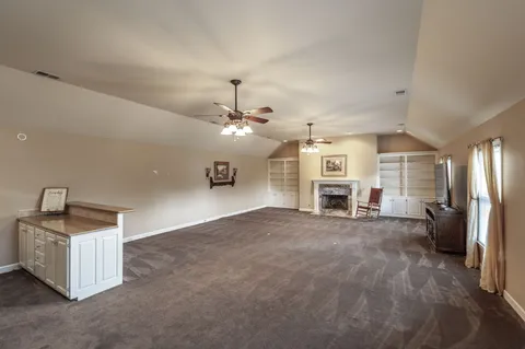 a living room with a bed and a window