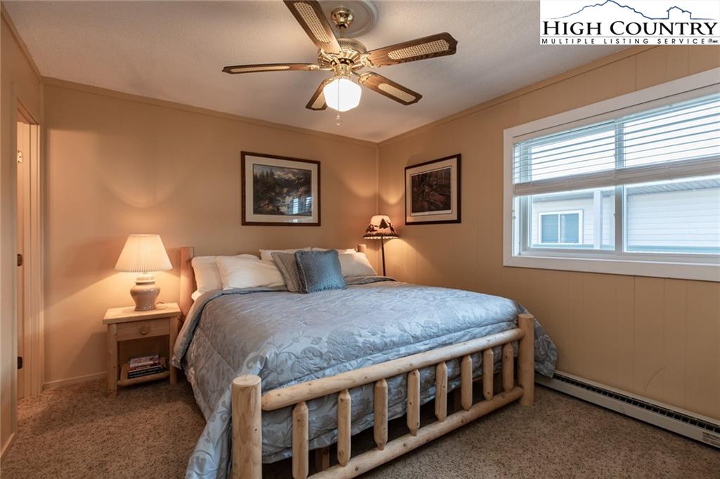 301 Pinnacle Inn Road, Unit 2316 Beech Mountain, NC 28604 - Photo 24 of 50 a bed room with a bed and a chandelier