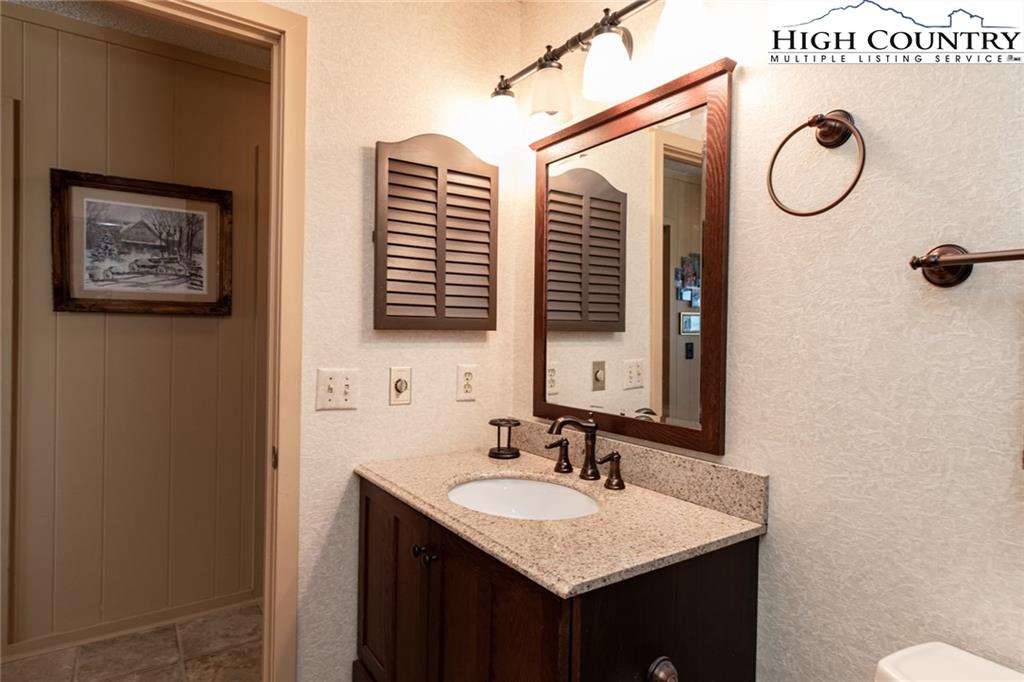 301 Pinnacle Inn Road, Unit 2316 Beech Mountain, NC 28604 - Photo 32 of 50 a bathroom with a sink and a mirror