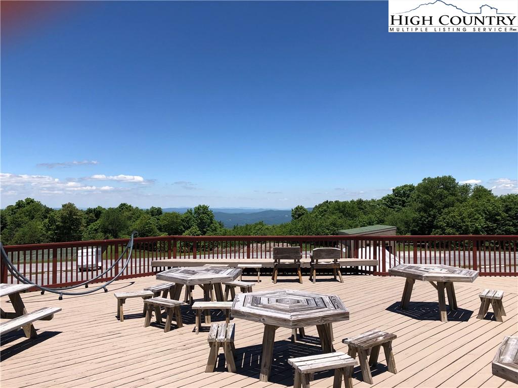 301 Pinnacle Inn Road, Unit 2316 Beech Mountain, NC 28604 - Photo 36 of 50 a view of a lake with couches and city view