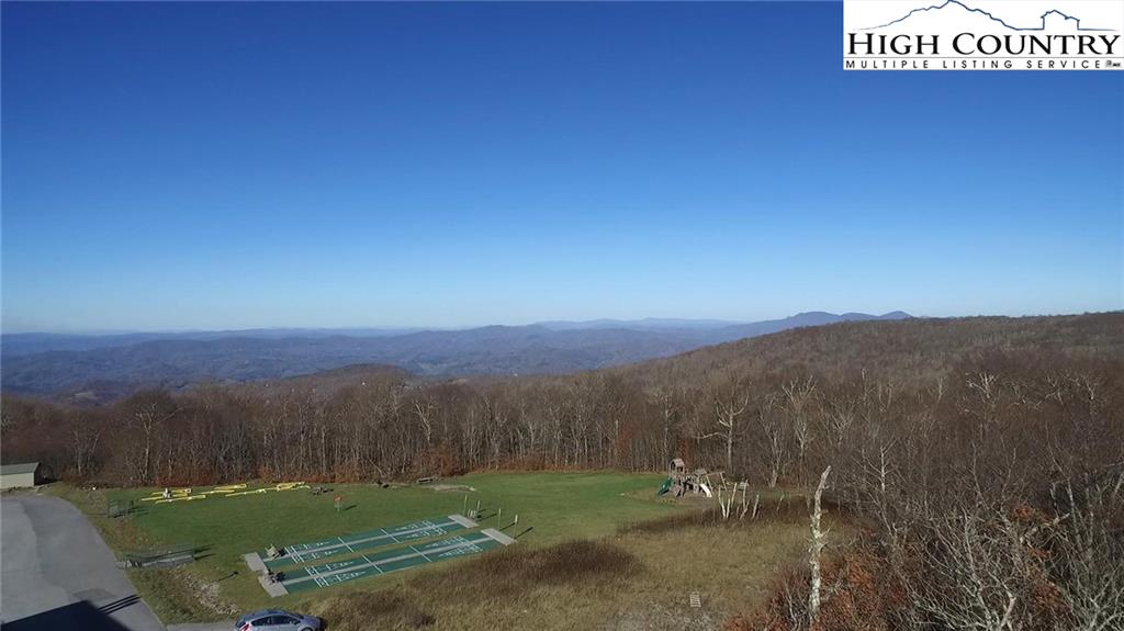 301 Pinnacle Inn Road, Unit 2316 Beech Mountain, NC 28604 - Photo 38 of 50 a view of a grassy area with mountains and a houses