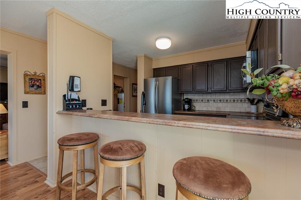 301 Pinnacle Inn Road, Unit 2316 Beech Mountain, NC 28604 - Photo 8 of 50 a kitchen with a table chairs sink and cabinets