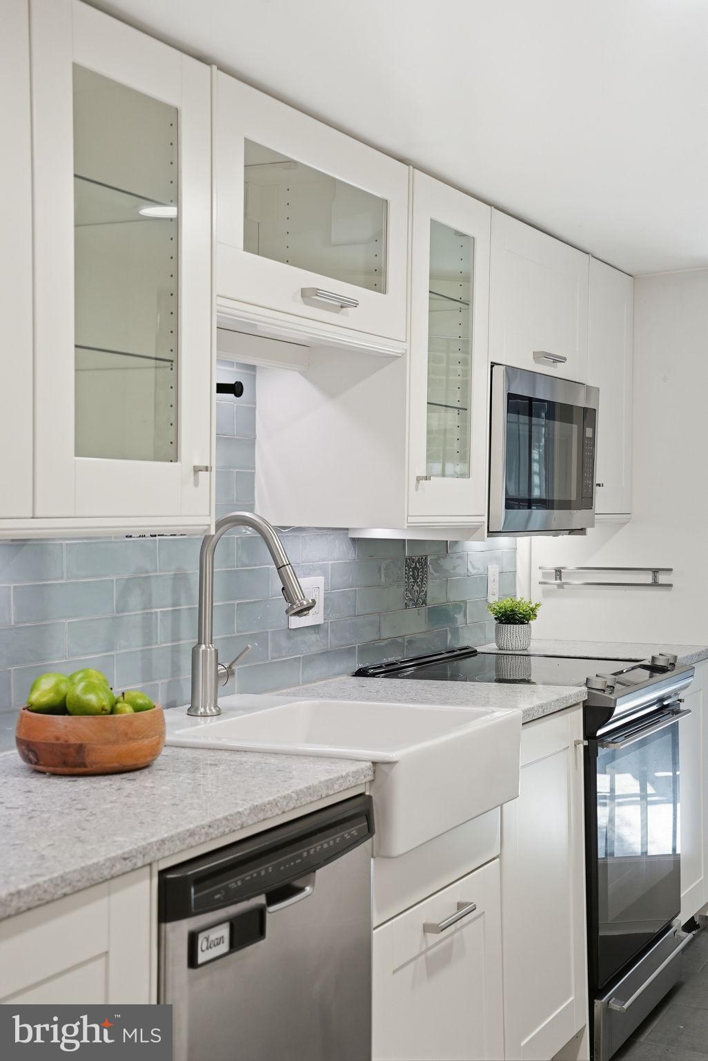 1200 East Capitol Street Northeast, Unit 1 Washington, DC 20002 - Photo 17 of 31 a kitchen with granite countertop a sink stainless steel appliances and cabinets