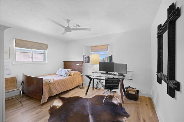 a bedroom with a workspace