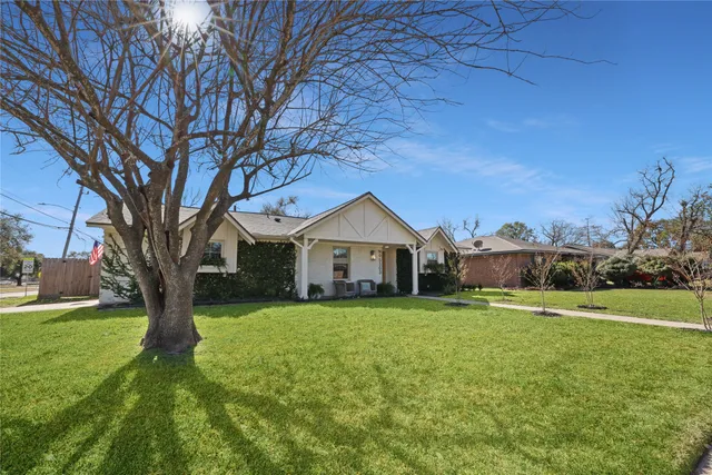 a backyard of a house with plants and outdoor seating