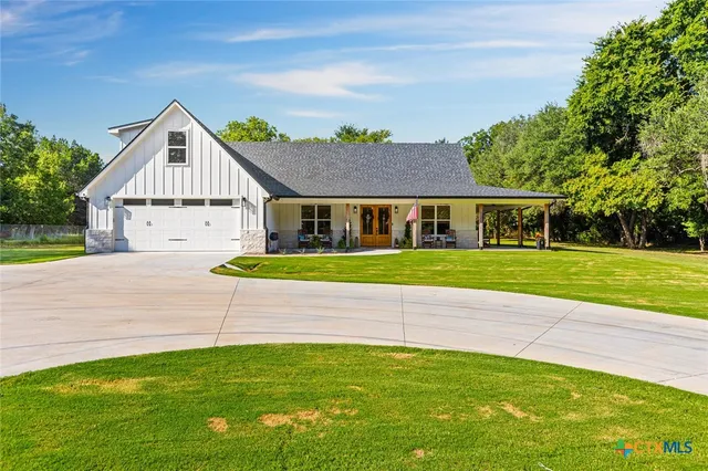 a view of house with a yard