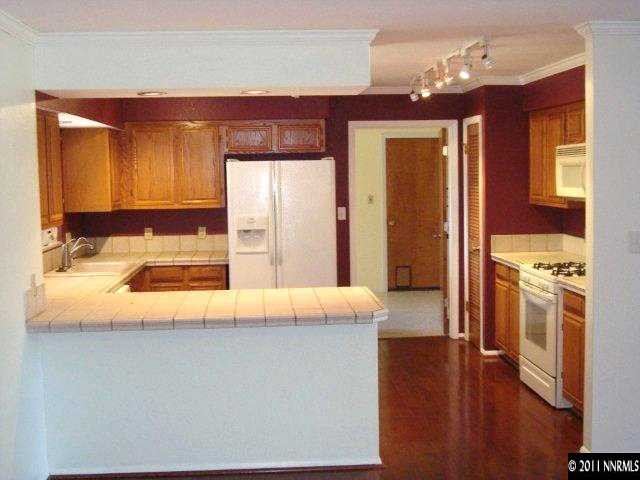 303 Rice Road Fallon, NV 89406 - Photo 6 of 13 a view of a kitchen with a refrigerator a stove top oven and a dishwasher